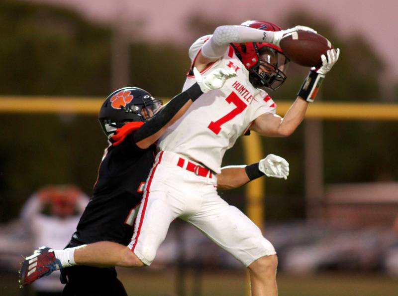 Huntley’s Wyatt Fleck, right, hauls in a pass in varsity football on Friday, Aug. 30, 2024, at Metcalf Field on the campus of Crystal Lake Central High School in Crystal Lake.