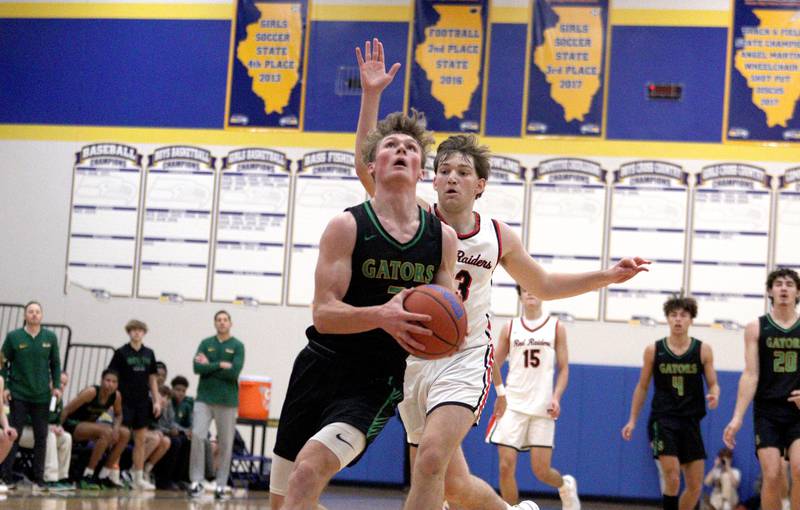 Crystal Lake South’s  Colton Hess takes the ball to the hoop in varsity basketball tournament title game action at Johnsburg Friday.