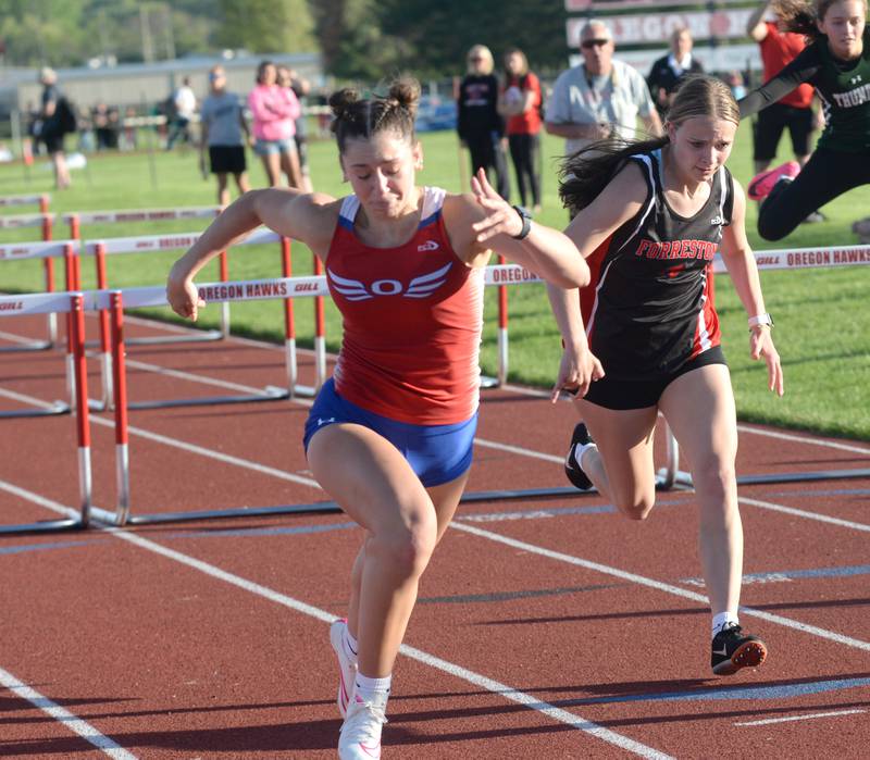 Oregon's Rylie Robertson (center) heads to the finish line in the 100 hurdles at the 1A Oregon Sectional on Friday. May 10, 2024. Robertson won the race in 17.26 seconds to qualify for the state finals at Eastern Illinois University in Charleston. Also pictured is Forreston-Polo's Courtney Grobe who finished fourth in the race.