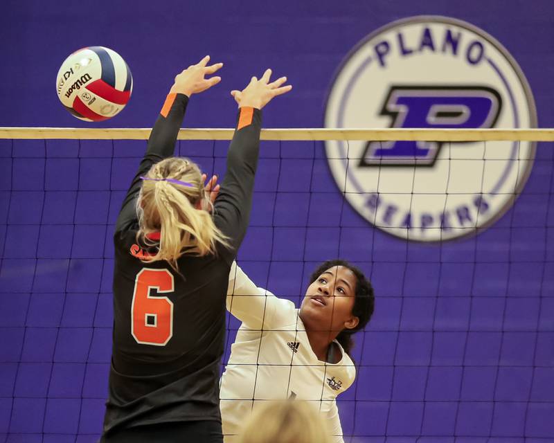 Plano's Jayln Harverly (10) spikes the ball during volleyball match between Sandwich at Plano.  August 21, 2023.