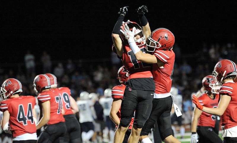 Yorkville defender Tristan Whisenant (12) celebrates with teammates, after a touchdown saving interception against Plainfield South on Friday, Sep. 30, 2024, at Yorkville High School.