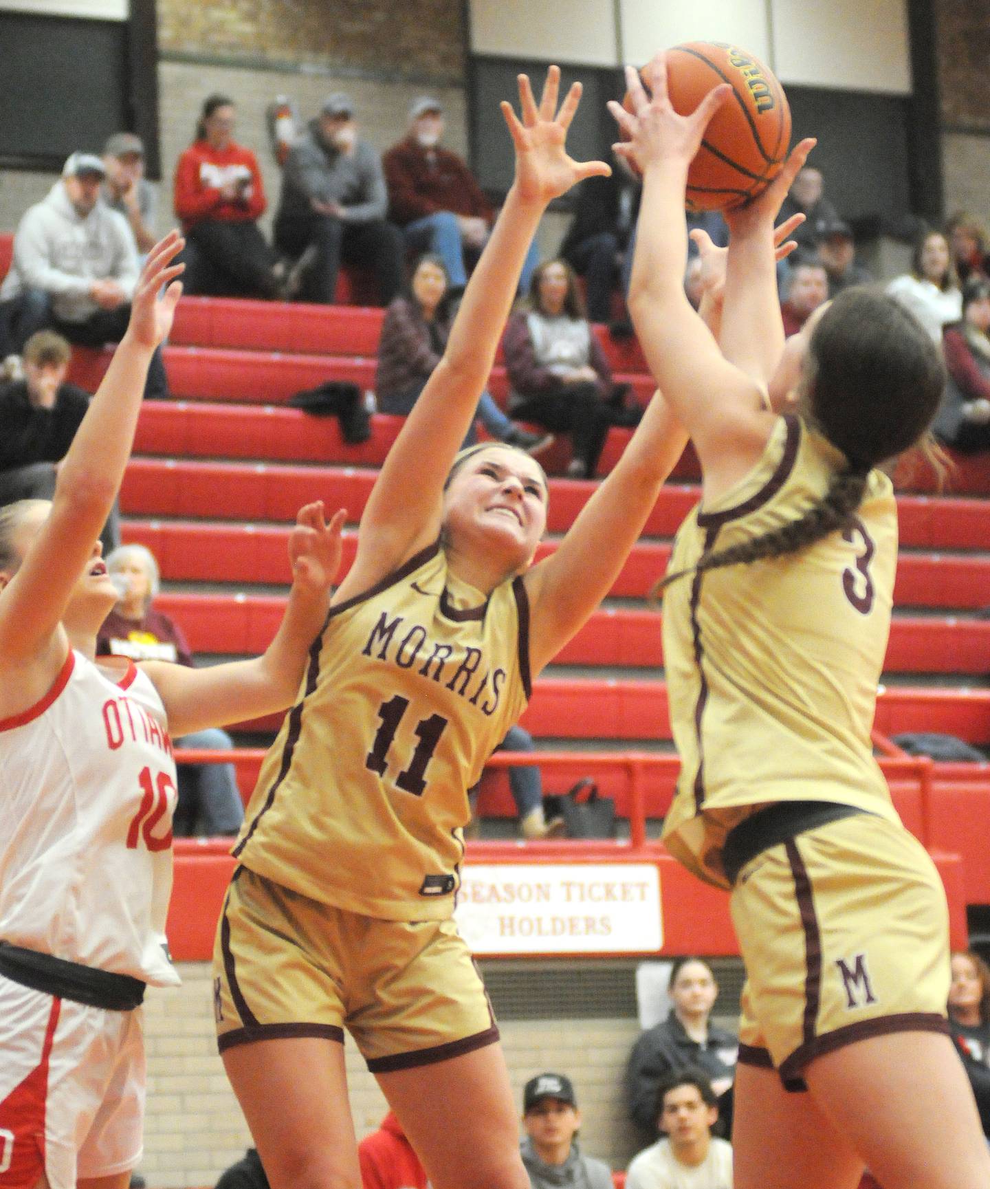 Ottawa's Ella Schmitz, and Morris' Alyssa Jepson (11) and Lily Hansen go for a rebound at Kingman Gym on Friday, Dec. 22, 2023.