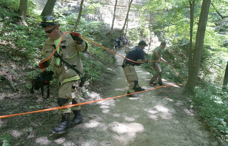 Oglesby firefighter Derek Vicich (left) conducts a rope rescue  for a male subject who fell at La Salle Canyon on Wednesday, July 17, 2024 at Starved Rock State Park.