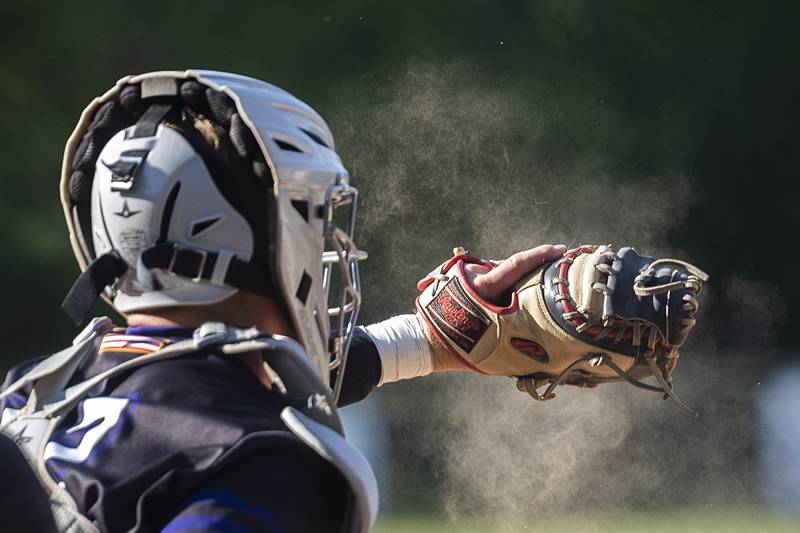 Dust kicks up from Dixon’s Aiden Wiseman glove against Freeport Thursday, May 23, 2024 during the Class 3A regional semifinal in Dixon.