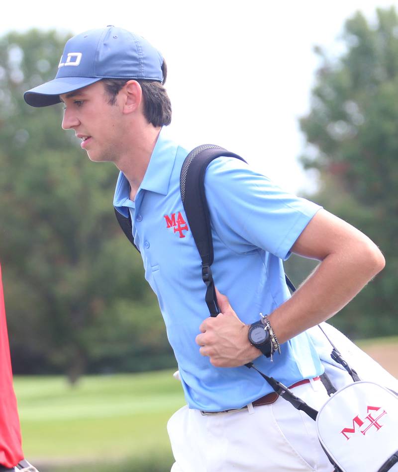 Marmion's Regan Konen carries his clubs to the second hole after teeing off during the Pirate Invitational golf meet on Monday, Sept. 16, 2024 at Deer Park Golf Course in Oglesby.