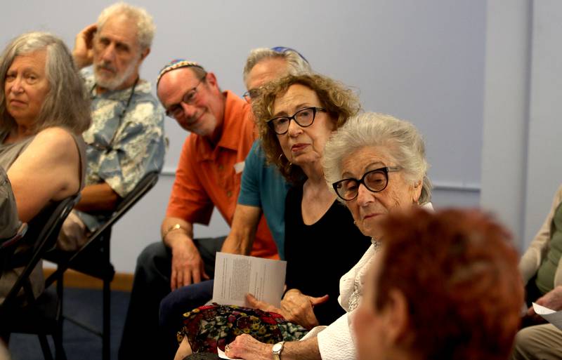 People listen carefully while fellow congregation members share memories as the McHenry County Jewish Congregation held a deconsecration ceremony at their Ridgefield Road location in preparation for a move to the Tree of Life Unitarian Church in McHenry on Sunday, August 18.