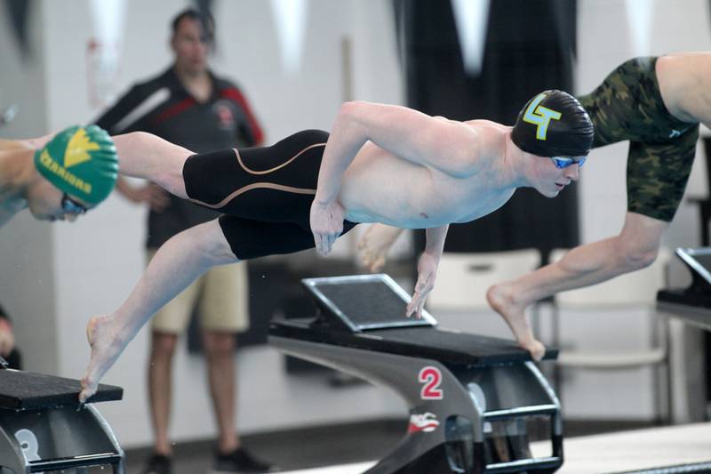 Lyons Township’s Quinn Collins takes off the blocks for the consolation heat of the 200-yard individual medley during the IHSA Boys State Championships at FMC Natatorium in Westmont on Saturday, Feb. 25, 2023.