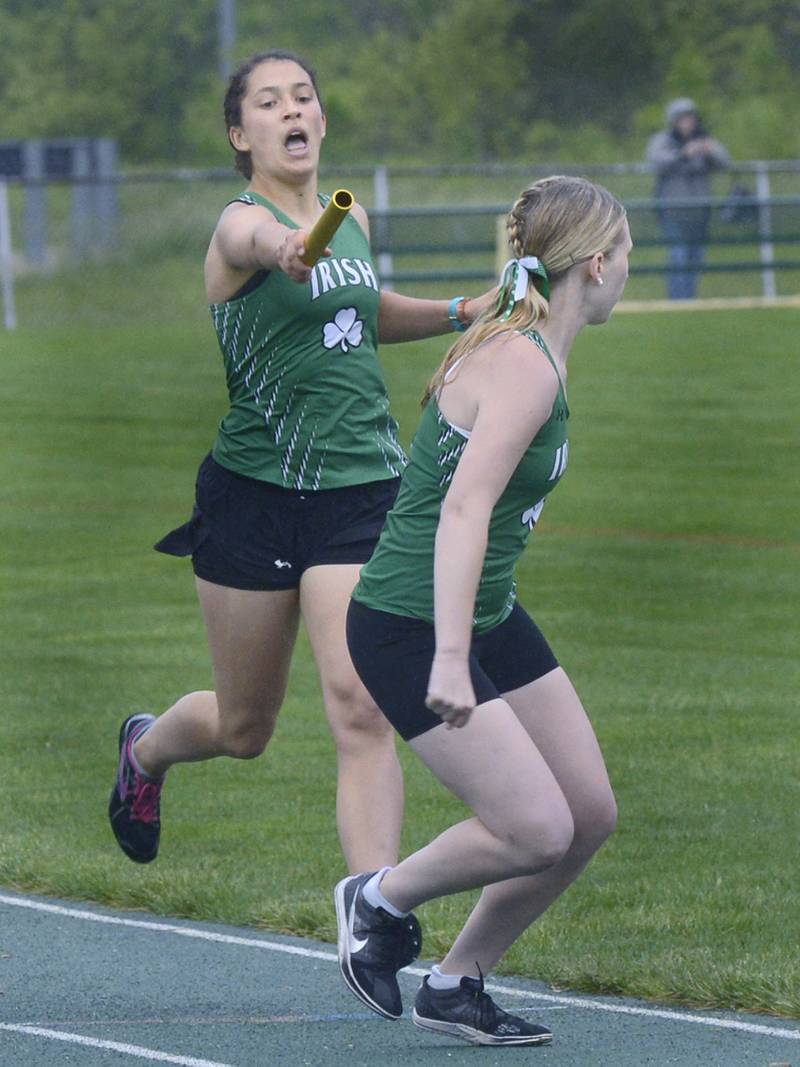 Seneca’s Clara Bruno hands off to teammate Natalie Misner in the 4x800 relay during Thursday’s girls sectional at Seneca.