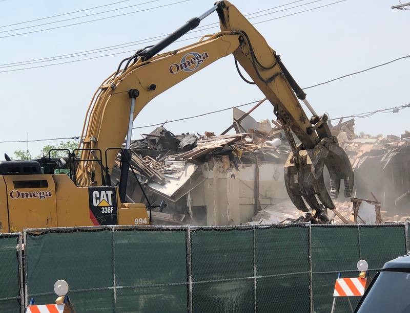 A crew does demolition work on a row of buildings in downtown Fox River Grove on May 21, 2024. The village hopes to redevelop the block.