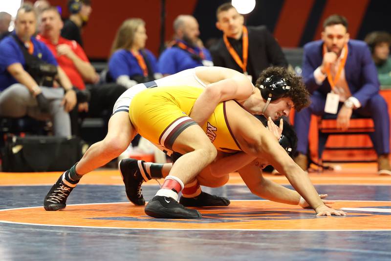 IC Catholic’s Brody Kelly works over Montini’s David Mayora in the 150-pound Class 2A state championship match on Saturday, Feb. 17th, 2024 in Champaign.