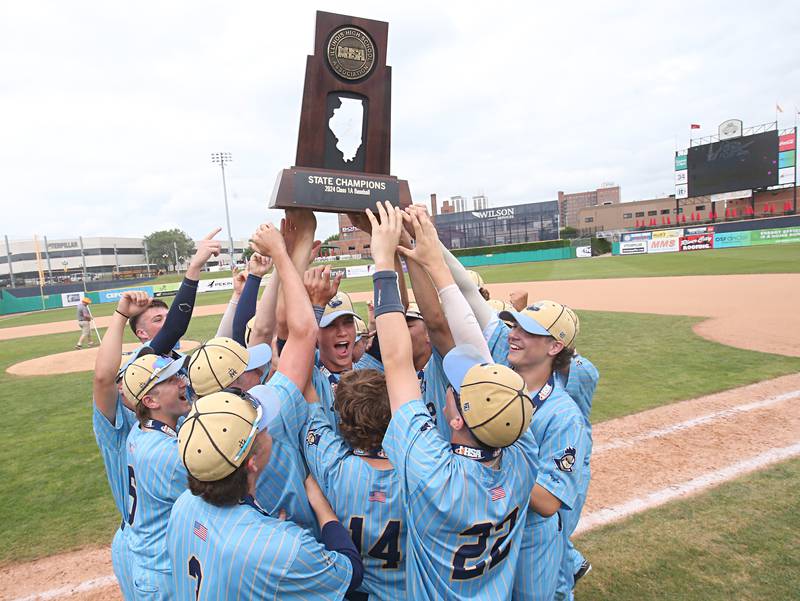 Members of the Marquette baseball team hoist the Class 1A championship trophy after defeating Altamont 6-2 to win the Class 1A championship on Saturday, June 1, 2024 at Dozer Park in Peoria.