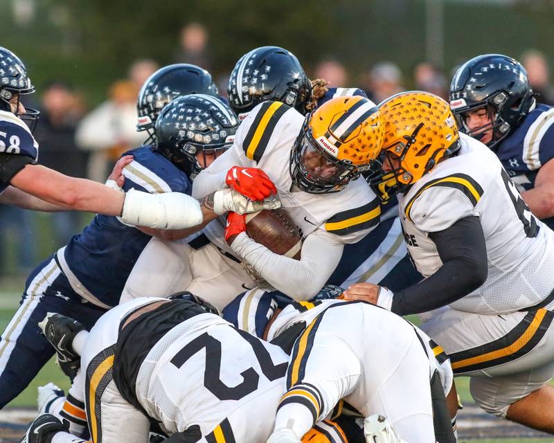 St Laurence's Aaron Ball (6) is caught in a scrum during Class 4A third round playoff football game between St Laurence at IC Catholic Prep.  Nov 11, 2023.