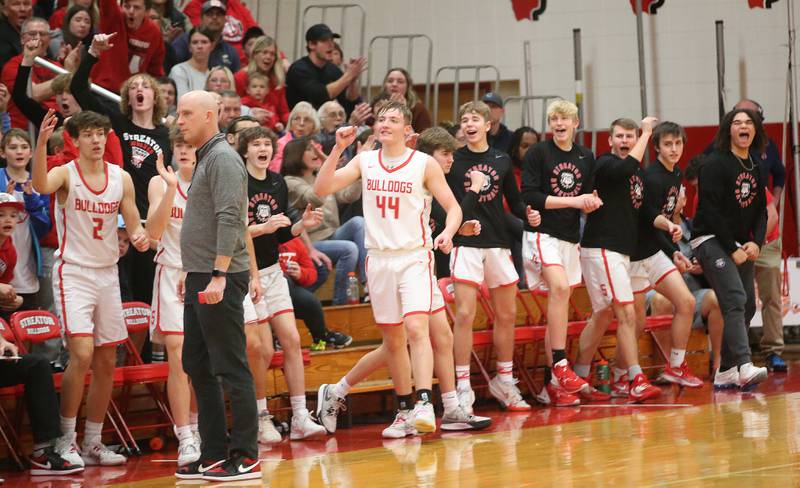 Members of the Streator boys basketball team react after teammate Landon Muntz sinks a jump shot against Pontiac during the Class 3A Regional semifinal game on Wednesday, Feb. 22, 2024 at Pops Dale Gymnasium.