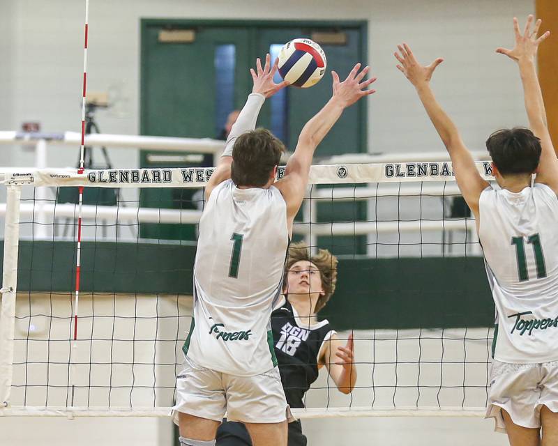 Downers Grove North's Dylan Quinn (18) with the kill attempt during volleyball match between Downers Grove North at Glenbard West.  April 2, 2024.