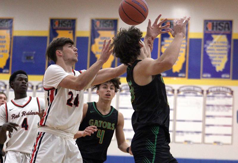 Huntley’s Ryan Sweeney, left, battles Crystal Lake South’s Christopher  Regillio in varsity basketball tournament title game action at Johnsburg Friday.