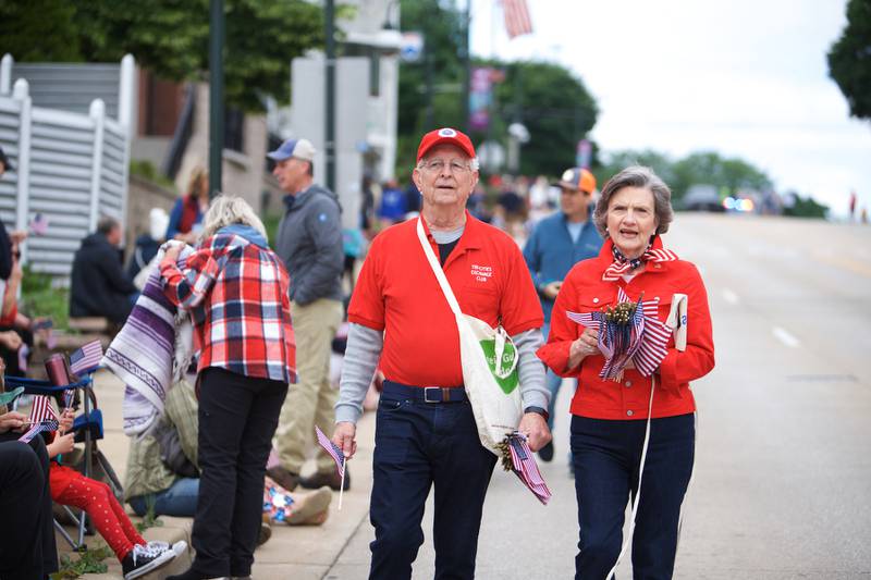 Members of the Tri-Cities Exchange Club hand out flags at the St. Charles Memorial Day Parade on Monday, May 27,2024 in St. Charles.