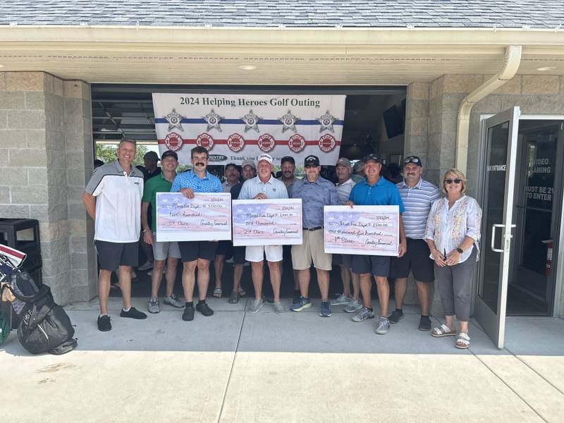 COUNTRY Financial representatives posing with participants in the First Annual “Operation Helping Heroes Golf Outing.