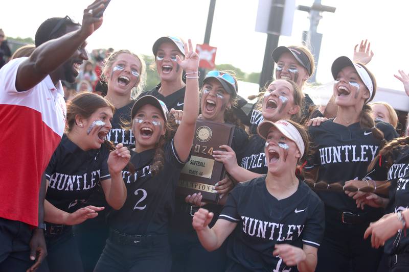 Huntley’s Red Raiders celebrate a win over Barrington in sectional final softball action at Barrington Friday.