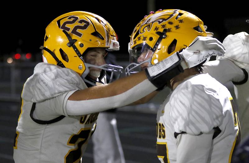 Jacobs' Luke Gormsen celebrates with his teammate, Jacobs’ Cooper Gulgren after  Gulgren intercepted a \pass by McHenry's Dayton Warren during a Fox Valley Conference football game on Friday, Oct. 18, 2024, at McKracken Field in McHenry.