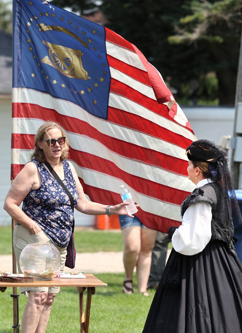 Kathy Berger, (left) from Paxton, asks questions of Susan McGlade, from Wauconda, a Civil War reenactor with Taylor’s Battery, 1st Illinois Light Artillery Company B, Saturday, July 15, 2023, at the Waterman Lions Summerfest and Antique Tractor and Truck Show at Waterman Lions Club Park.