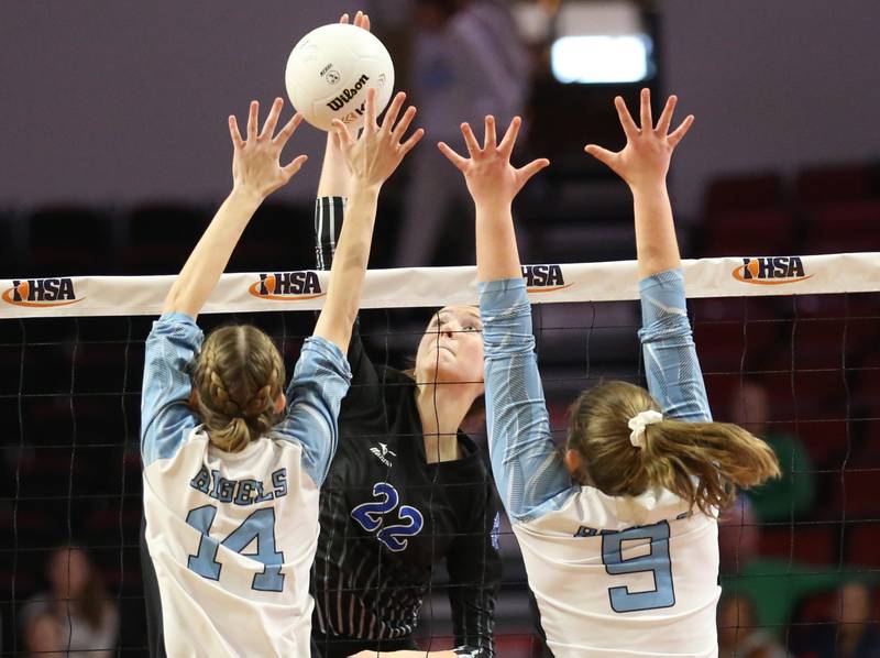 St. Francis's Addy Horner (22) sends a kill past Joliet Catholic's Emma Vitas (14) and teammate Jessica Horn (9) in the Class 3A semifinal game on Friday, Nov. 11, 2022 at Redbird Arena in Normal.