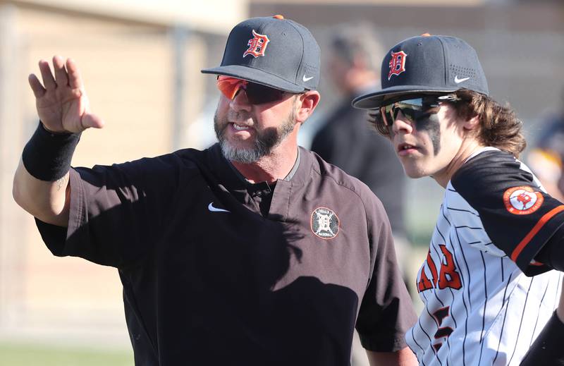 DeKalb head coach Joshua Latimer talks to Cole Latimer during their game against Metea Valley Thursday, April 13, 2023, at DeKalb High School.