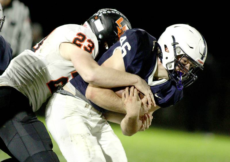 Cary-Grove’s Logan Abrams carries the ball against Libertyville  in first-round Class 6A playoff  football action at Cary Friday.