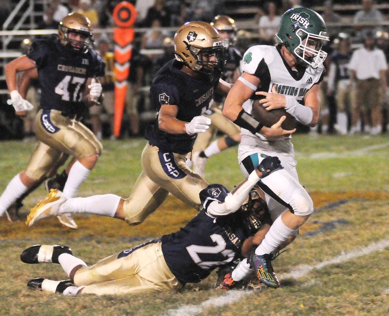 Seneca's Paxton Giertz is tackled by Marquette's Connor Baker (22) and Payton Gutierrez at Gould Stadium on Friday, Sept. 13, 2024.