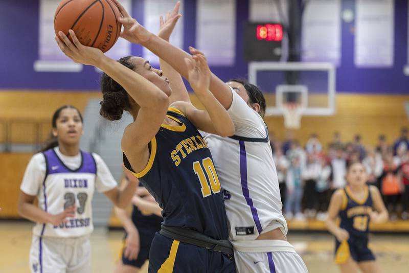 Sterling’s Nia Harris puts up a shot against Dixon’s Hallie Williamson Tuesday, Feb. 13, 2024 during a regional semifinal at Rochelle.