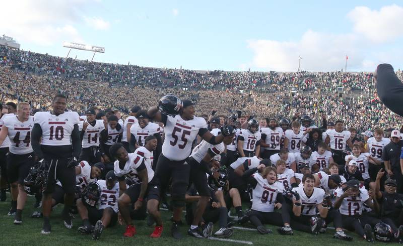 Members of the NIU football team celebrate after beating Notre Dame on Saturday, Sept. 7, 2024 at Notre Dame Stadium.