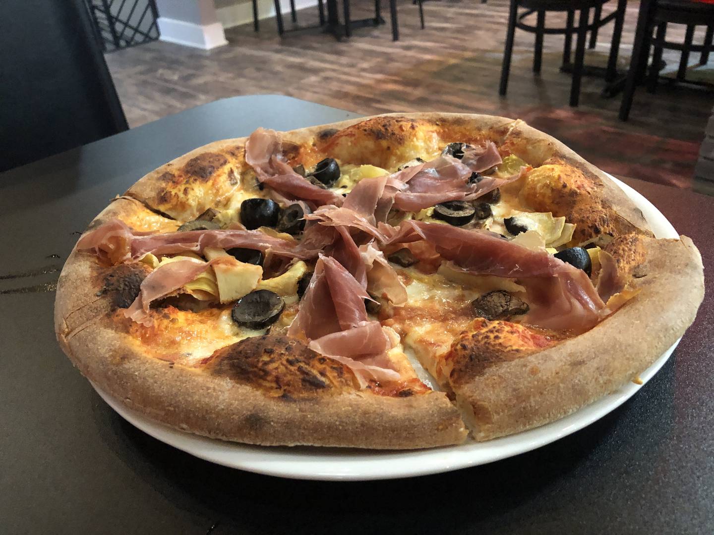 Capricciosa pizza with prosciutto, artichokes, fresh mozzarella, portabella mushrooms & black olives at Bella's Wood Fire Pizzeria, 123 S. Main St., Algonquin