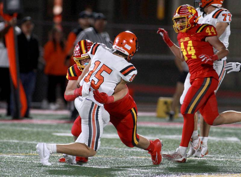 Batavia’s Xavier Blanquel tackles Wheaton Warrenville South quarterback Luca Carbonaro on Friday, Oct. 18, 2024 during a game at Batavia.