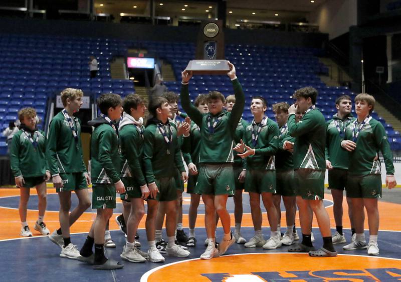 Wrestlers from Coal City raise their second place trophy after losing to Marina Central in the IHSA Class 1A Dual Team Sate Championship on Saturday, Feb. 24, 2024 at Grossinger Motors Arena in Bloomington.