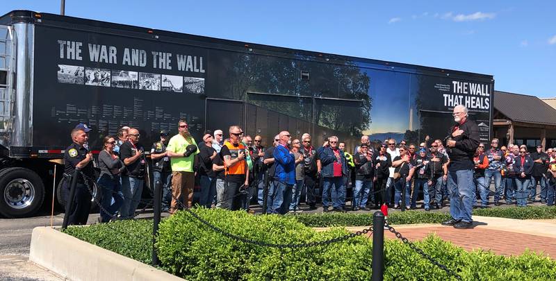 Participants in "The Wall that Heals" processional stand at attention at the Woodstock Harley Davidson May 22, 2024.