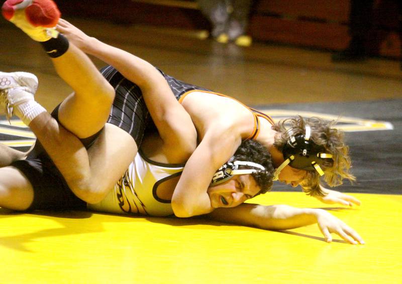 Jacobs’ John Strauss, front, battles Crystal Lake Central’s Cayden Parks at 170 pounds in varsity wrestling Thursday at Algonquin.