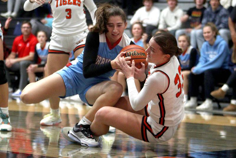 Crystal Lake Central’s  Kathryn Hamill, right, tussles with Marian Central’s Ella Notaro, left, in Northern Illinois Holiday Classic championship girls basketball game action at  McHenry High School Thursday.