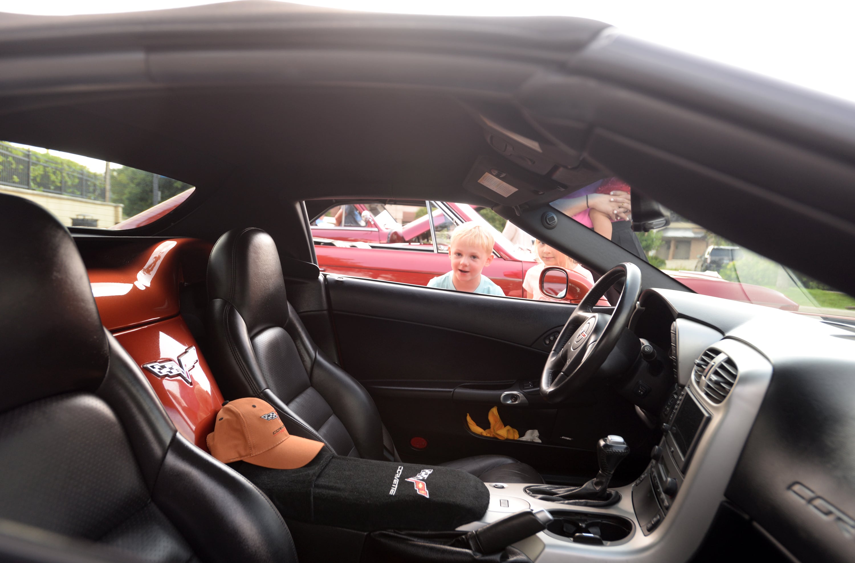 Maxi and Robin Baden of Downers Grove take a look inside a 2005 Corvette during the Downers Grove Car Show Friday July 19, 2024.