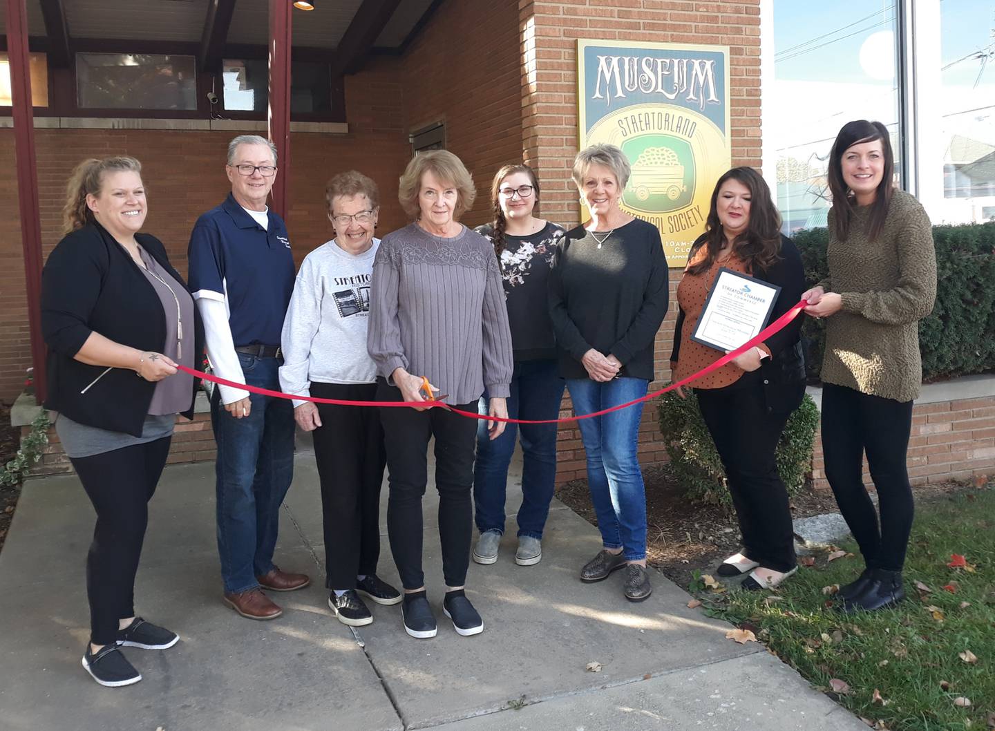 Megan Wright, member services coordinator at the Streator Chamber of Commerce; Dave Reed, president of the Streatorland Historical Society; Pat Breen, board member of the Streatorland Historical Society; Mary Lou Anderson, museum director; Leah Anderson, museum assistant; Sharon Walkey, board member of the Streatorland Historical Society; Mayor Tara Bedei; and Courtney Levy, chamber president cut the ceremonial ribbon Friday, Oct. 14, 2022, commemorating the opening of the museum earlier this year.