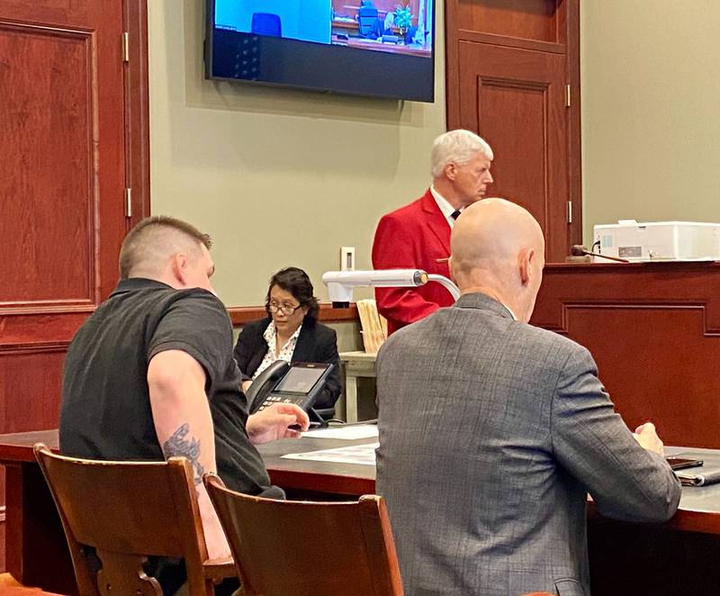 Former police officer James M. Corralejo, 25, of DeKalb, (left), reaches for his driver's license next to his defense attorney Camic Johnson (right) at the DeKalb County Courthouse in Sycamore on Wednesday, May 29, 2024. Circuit Court Judge Philip Montgomery ordered Corralejo's license revoked, ruling he violated the conditions of his pretrial release when he used skin ointment with alcohol in it while he wore an ankle bracelet in March and April 2024. Corralejo is free on release pending DUI charges in the fatal Nov. 5, 2023, crash that killed DeKalb woman Graciela Reza Contreras.