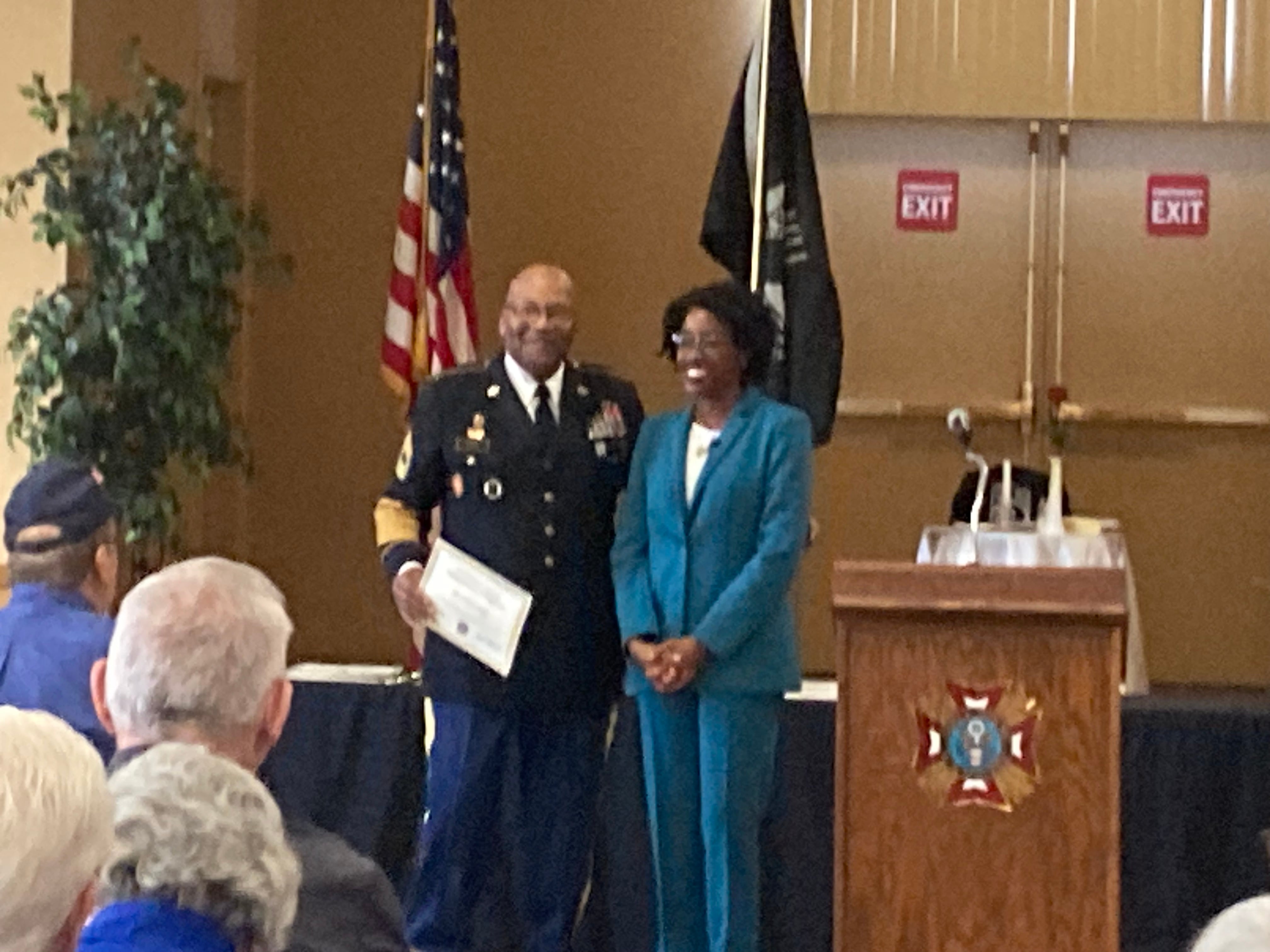 William Bijou receives his certificate from Representative Lauren Underwood at the Veterans Day pinning ceremony in Joliet.