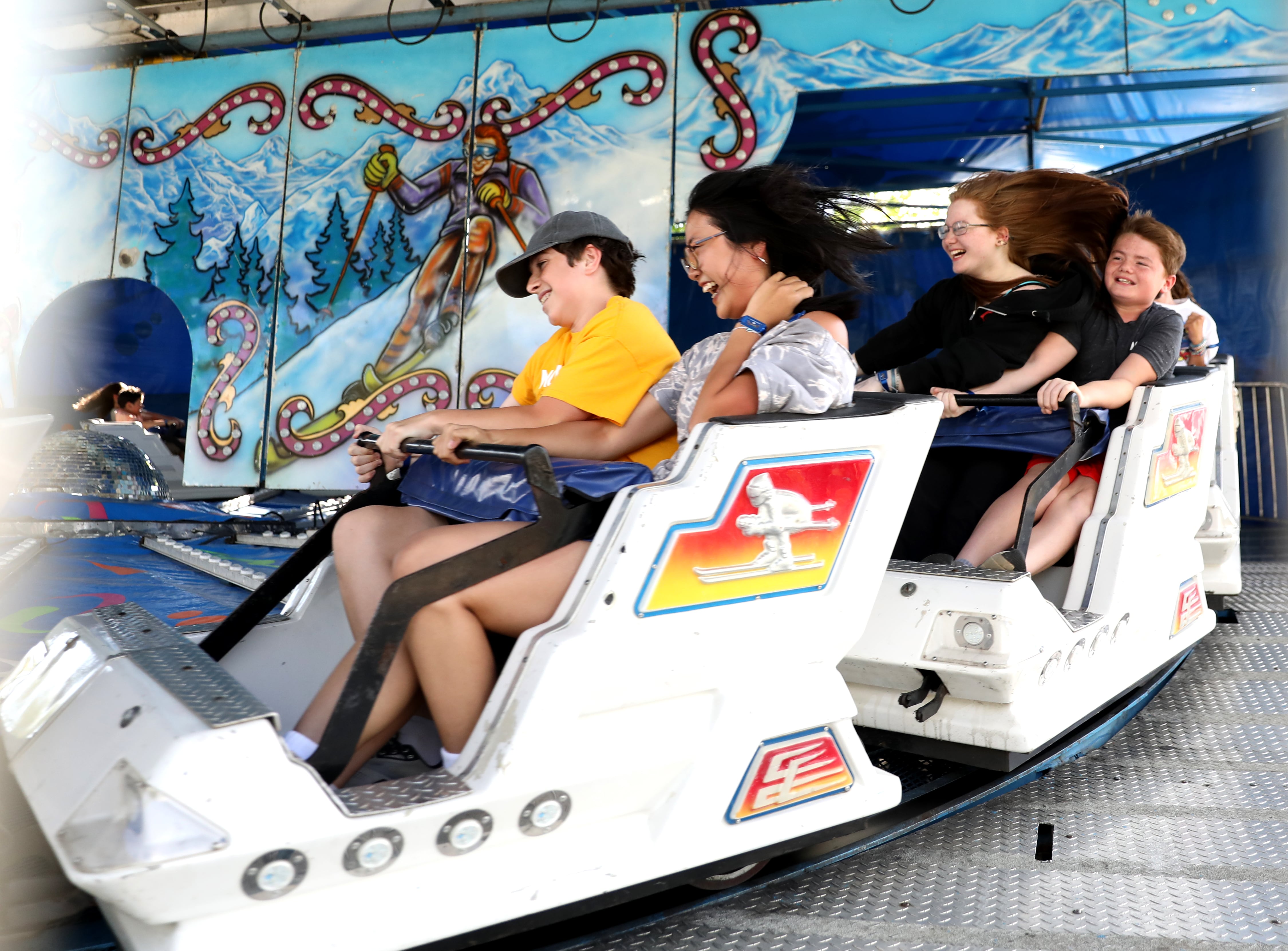 Riders cruise by on the Matterhorn ride during opening day of the 155th Kane County Fair opened in St. Charles on Wednesday, July 17, 2024. The fair runs through Sunday, July 21, 2024.