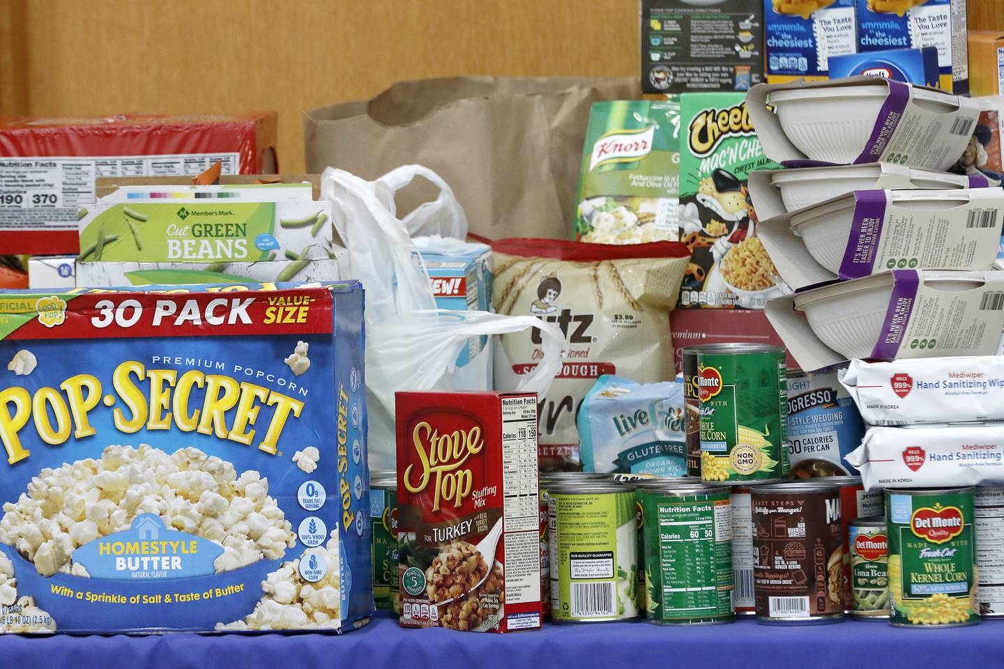 Donations are stacked on a table during a Community Harvest food drive on Friday, Nov. 19, 2021, at Northwestern Medicine Health and Fitness Center in Crystal Lake. About 40 sponsoring sites helped contribute to the annual food collection and donation campaign for the Crystal Lake Food Pantry.