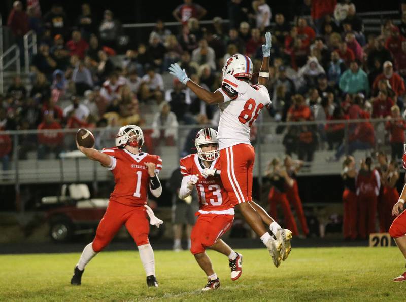 Streator quarterback Isaiah Weibel throws a pass as teammate Anthony Mohr keeps Ottawa's Hector Valdez away from the play on Friday, Sept. 6, 2024 at Doug Dieken Stadium.