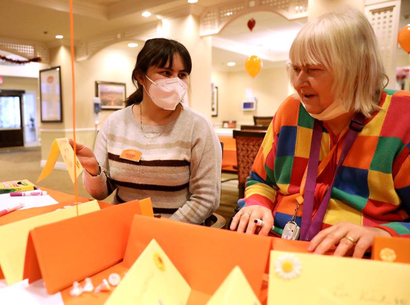 Brighton Gardens of St. Charles activity assistant Yelena Deseano and resident Nancy Patterson create kindness table signs for Lazarus House shelter, St. Charles Public Library and River Crossing senior living facility as part of the sixth annual Random Acts of Kindness Week sponsored by Random Acts Matter, a volunteer organization committed to sharing care and compassion in St. Charles.