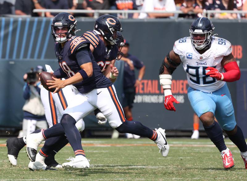 Chicago Bears quarterback Caleb Williams scrambles away from Tennessee Titans defensive tackle Jeffery Simmons during their game Sunday, Sept. 8, 2024, at Soldier Field in Chicago.