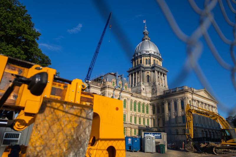 Construction vehicles are pictured outside of the Illinois State Capitol last month.