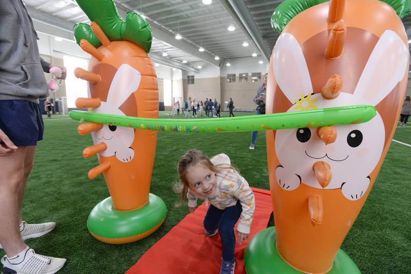 Reese Yarnall of Glen Ellyn participates in a limbo contest during the Glen Ellyn Park District's Hoppy party Saturday, March 30, 2024.