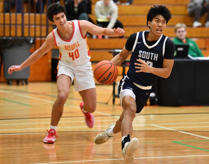 Downers Grove South's Richard Gasmen drives to the basket in front of Batavia's C.J. Valente (40) during a Jack Tosh Classic game on Dec. 26, 2023 at York High School in Elmhurst.