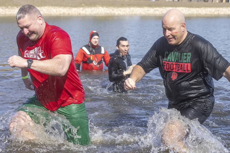 LaSalle Peru Highschool teacher Kevin Keating and Superintendent Steven Wrobleski spring out of the cold water of Lake Mendota during the Special Olympics Polar Plunge on February 24, 2024.
