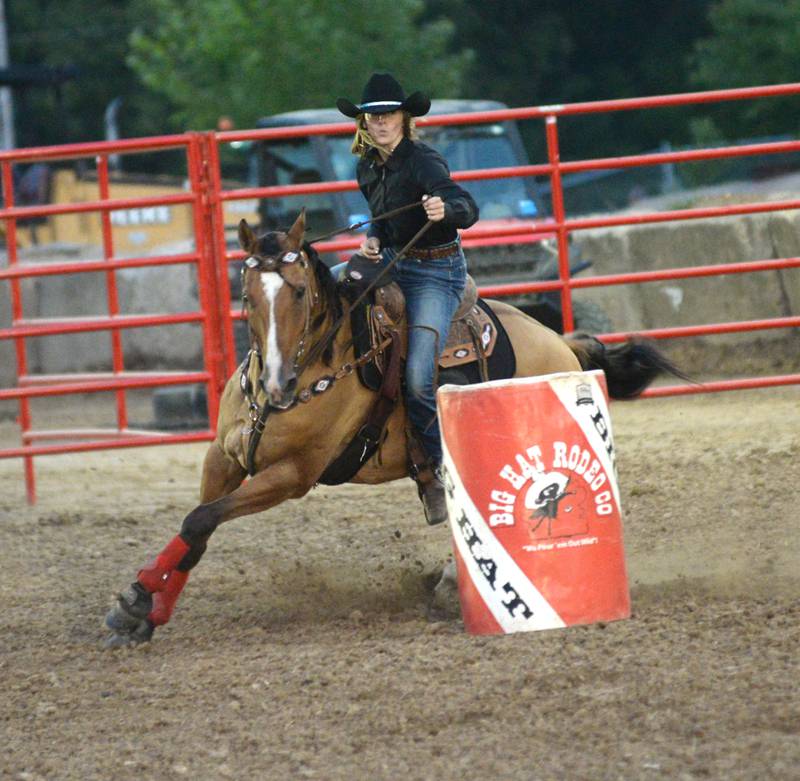 Jenavieve Schumacher of Dixon turns her horse around the last barrel during competition at the Big Hat Rodeo at the Ogle County Fair on Friday, Aug. 4, 2023.